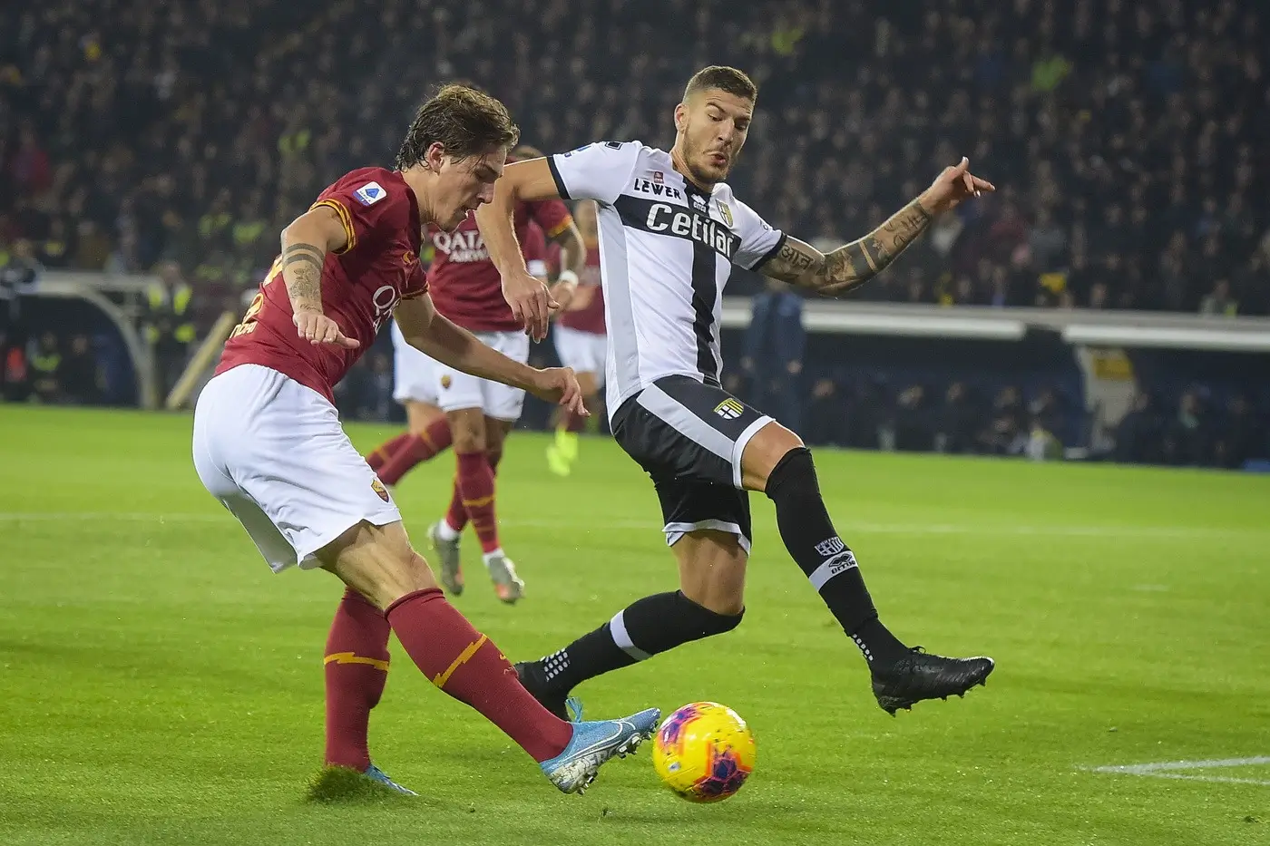 AS Roma player in red and yellow contests a yellow‑purple ball with Parma player in black and white — 1xBet Promo Code