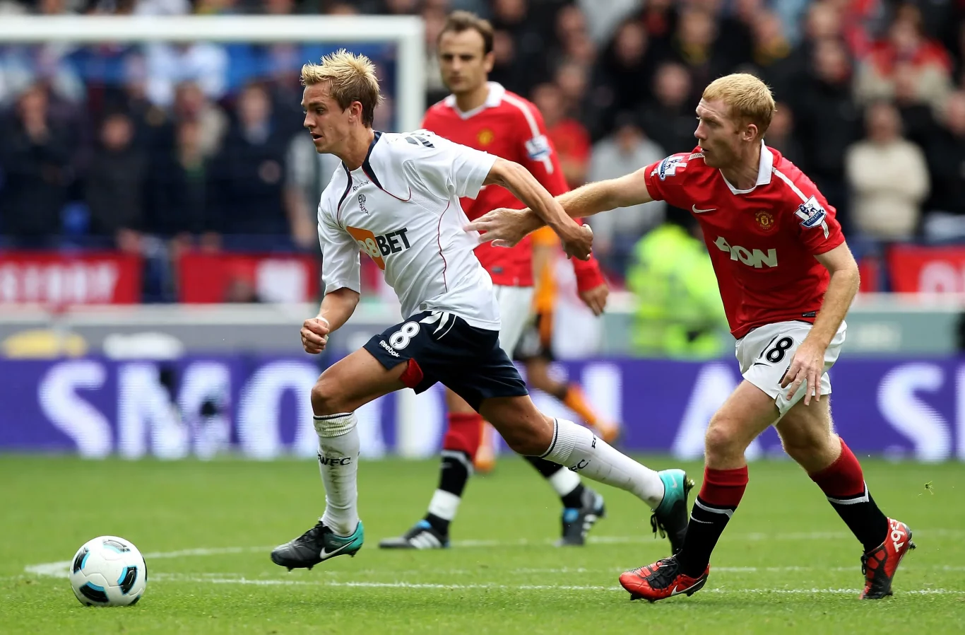 Bolton Wanderers player dribbling under pressure from Manchester United — 1xBet Sri Lanka football scene