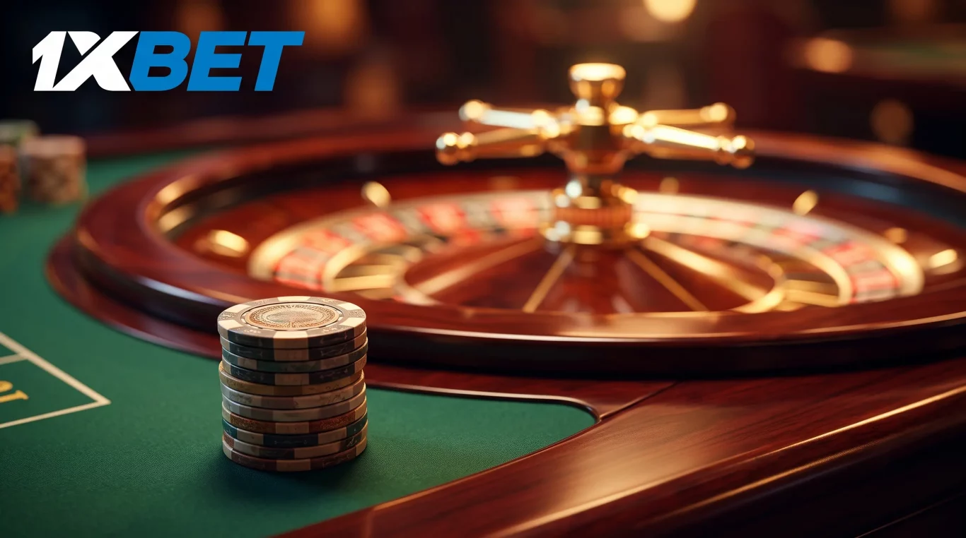 A detailed, close-up photograph of a neat stack of dark, custom casino chips on a green roulette felt table. The polished wooden and brass roulette wheel is beautifully blurred in the background under warm, dramatic lighting, with bokeh from the casino lights. The white 1XBET logo is clearly visible in the top-left corner